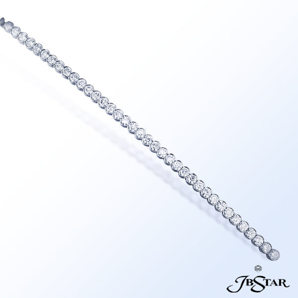 JB STAR BRILLIANT ROUND DIAMONDS SET IN A STRAIGHT-LINE 18KW BEZEL SETTING.DIAMONDS: 7.46 CT. TW.