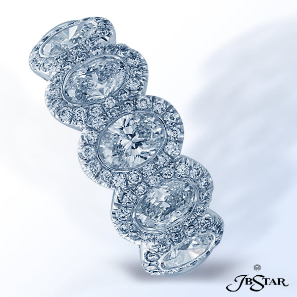 JB STAR DIAMOND BAND WITH 5 BEZEL-SET OVAL DIAMONDS, EACH ENCIRCLED WITH PAVE AND SET IN PLATINUM.