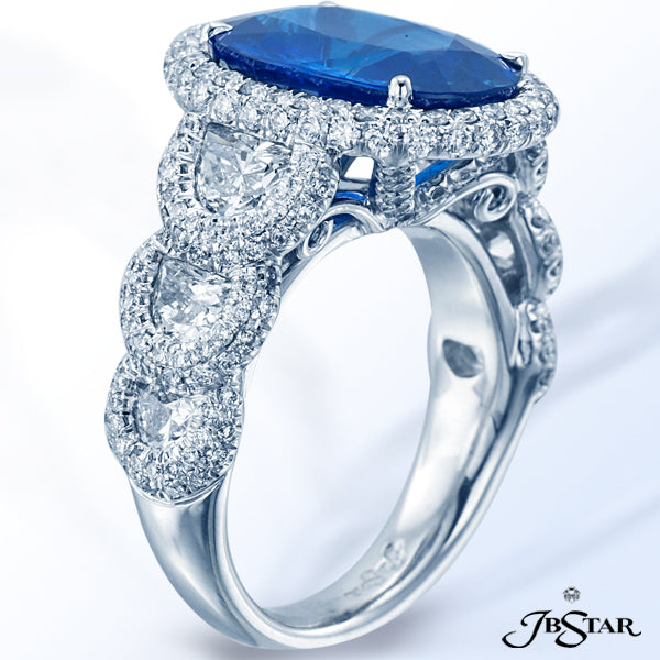 JB STAR SAPPHIRE RING FEATURING A BEAUTIFUL 6.20 CT OVAL BLUE SAPPHIRE EMBRACED BY CAREFULLY MATCHED