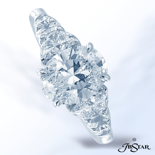 JB STAR DIAMOND PLATINUM RING FEATURING A 2.01 CT OVAL DIAMOND EMBRACED BY PERFECTLY MATCHED HALF MO