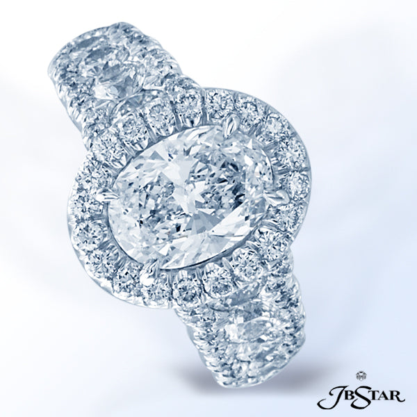 JB STAR PLATINUM DIAMOND RING FEATURING A VIBRANT OVAL DIAMOND, SET IN A MICRO PAVE HALO SETTING AND