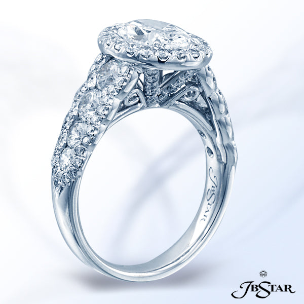 JB STAR PLATINUM DIAMOND RING FEATURING A VIBRANT OVAL DIAMOND, SET IN A MICRO PAVE HALO SETTING AND