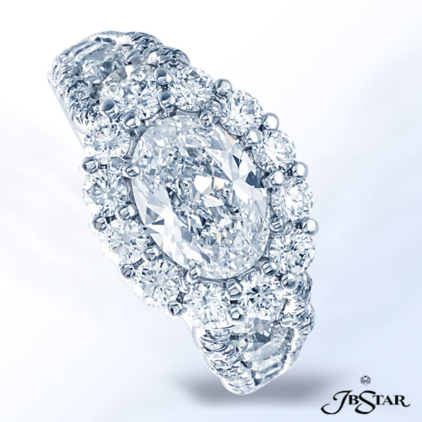 JB STAR DIAMOND ENGAGEMENT RING FEATURING A 1.50 CT OVAL DIAMOND SURROUNDED BY ROUND DIAMONDS AND FU