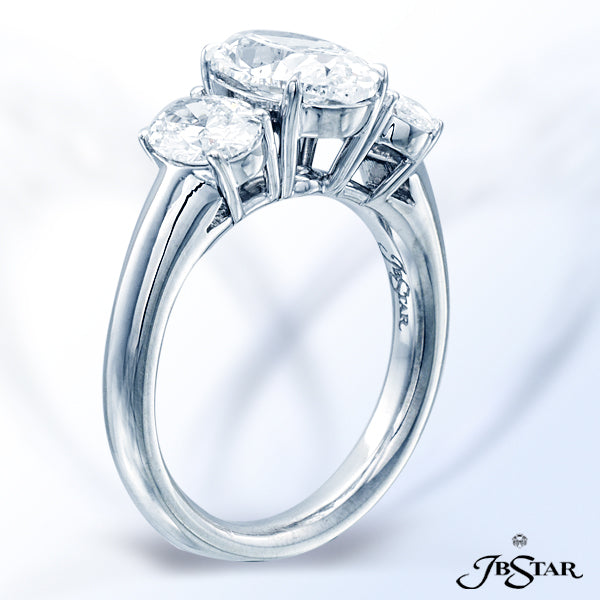 JB STAR DIAMOND RING FEATURING A LOVELY 2.03 CT OVAL DIAMOND EMBRACED BY TWO ADDITIONAL PERFECTLY MA