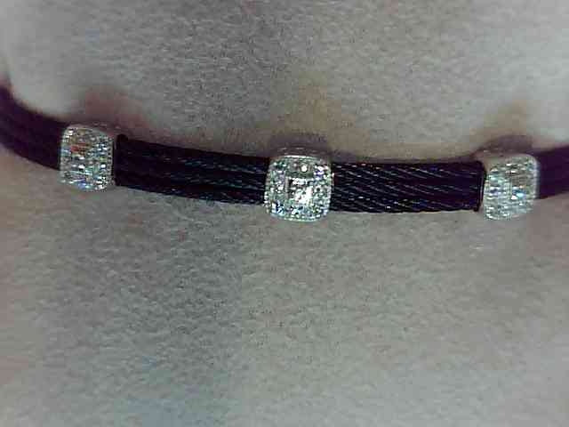 Alor Black cable 3 row 1.6 mm, 18 karat White Gold, 0.14 total carat weight Diamonds and stainless steel. Imported.